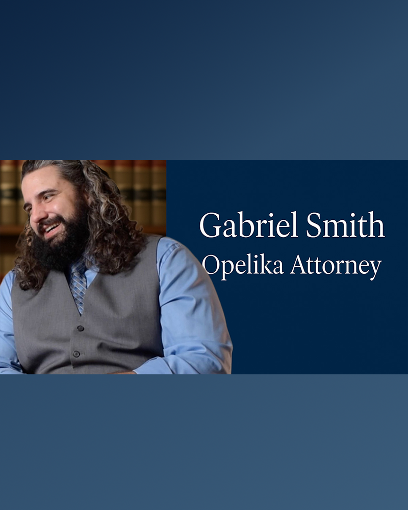Attorney Gabriel Smith smiling in his Opelika office